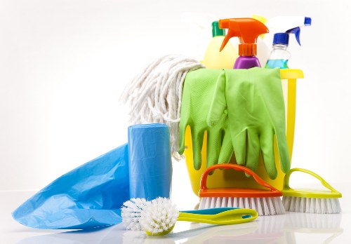 Professional cleaner tidying a modern apartment kitchen in Shoreditch